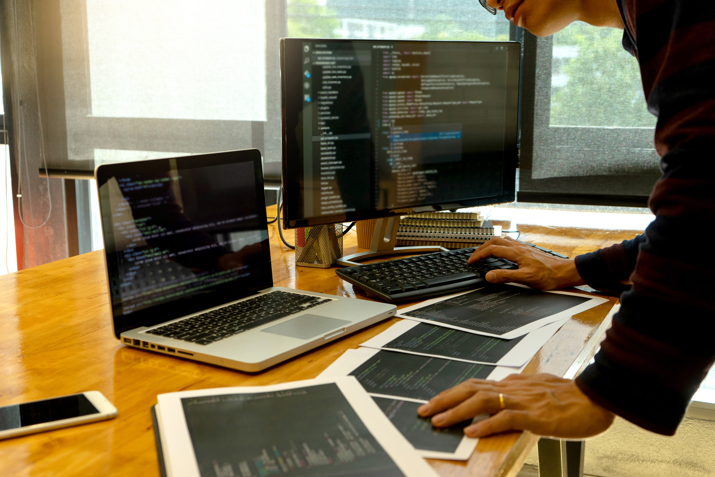Developer comparing technology options on laptop